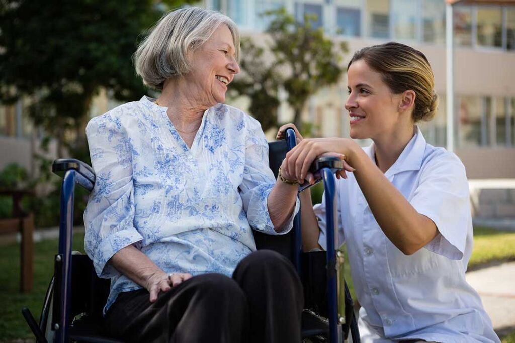 A senior resident using a tablet video call with family in a cozy assisted living apartment.